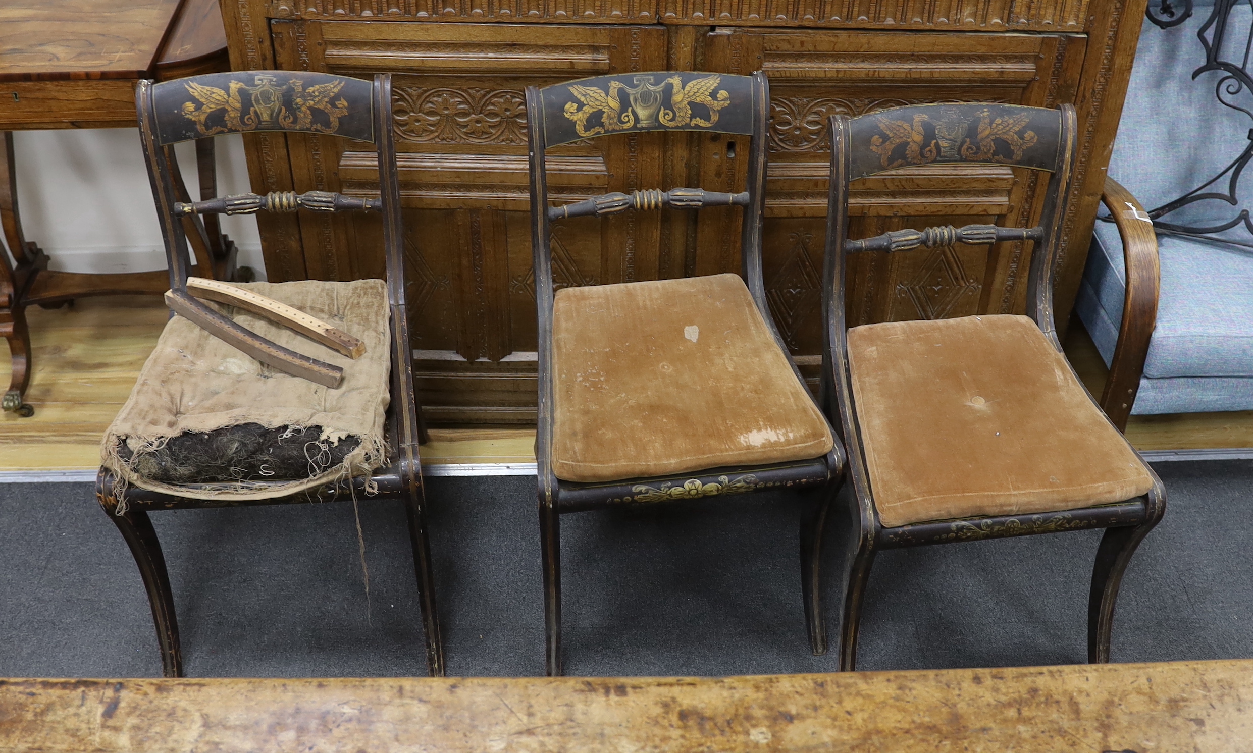 A set of eight Regency painted cane seat dining chairs, two with arms (in need of restoration)